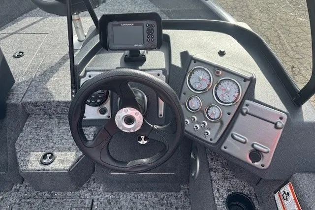 Slide: The Image of Dashboard of 2025 Tracker Pro Guide V-175 WT with steering wheel and gauges. - 14