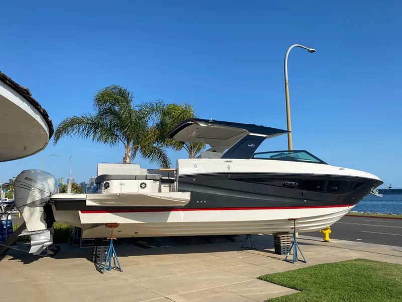 Slide: The Image of 2021 Sea Ray SLX 400 Outboard on a trailer by the water. - 2