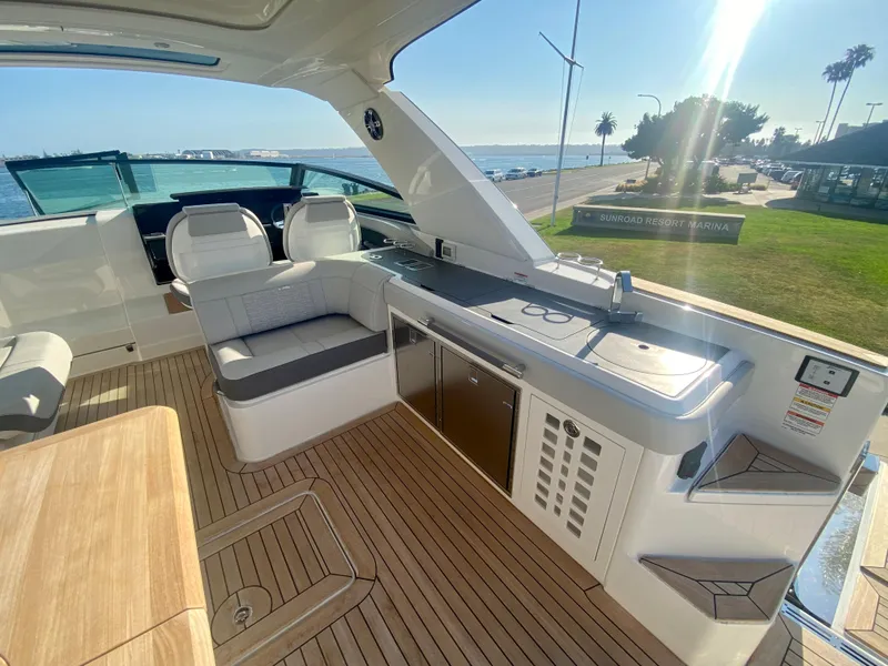 Slide: The Image of 2021 Sea Ray SLX 400 Outboard interior with seating and kitchenette. - 8