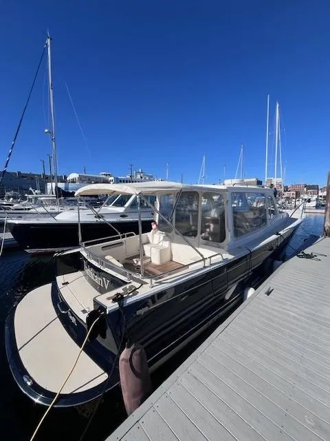 Slide: The Image of 2014 MJM 36z Downeast boat docked at marina under clear blue sky. - 13