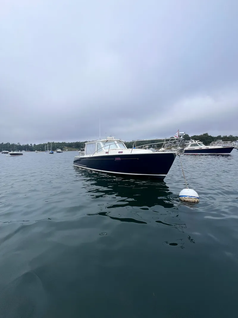 Slide: The Image of 2014 MJM 36z Downeast boat on calm water, overcast sky. - 20