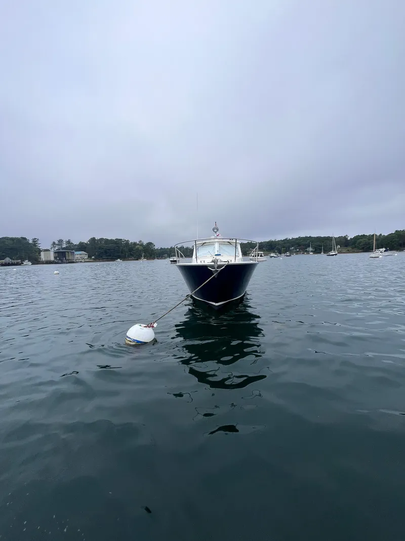 Slide: The Image of 2014 MJM 36z Downeast boat moored on calm water under cloudy sky. - 21