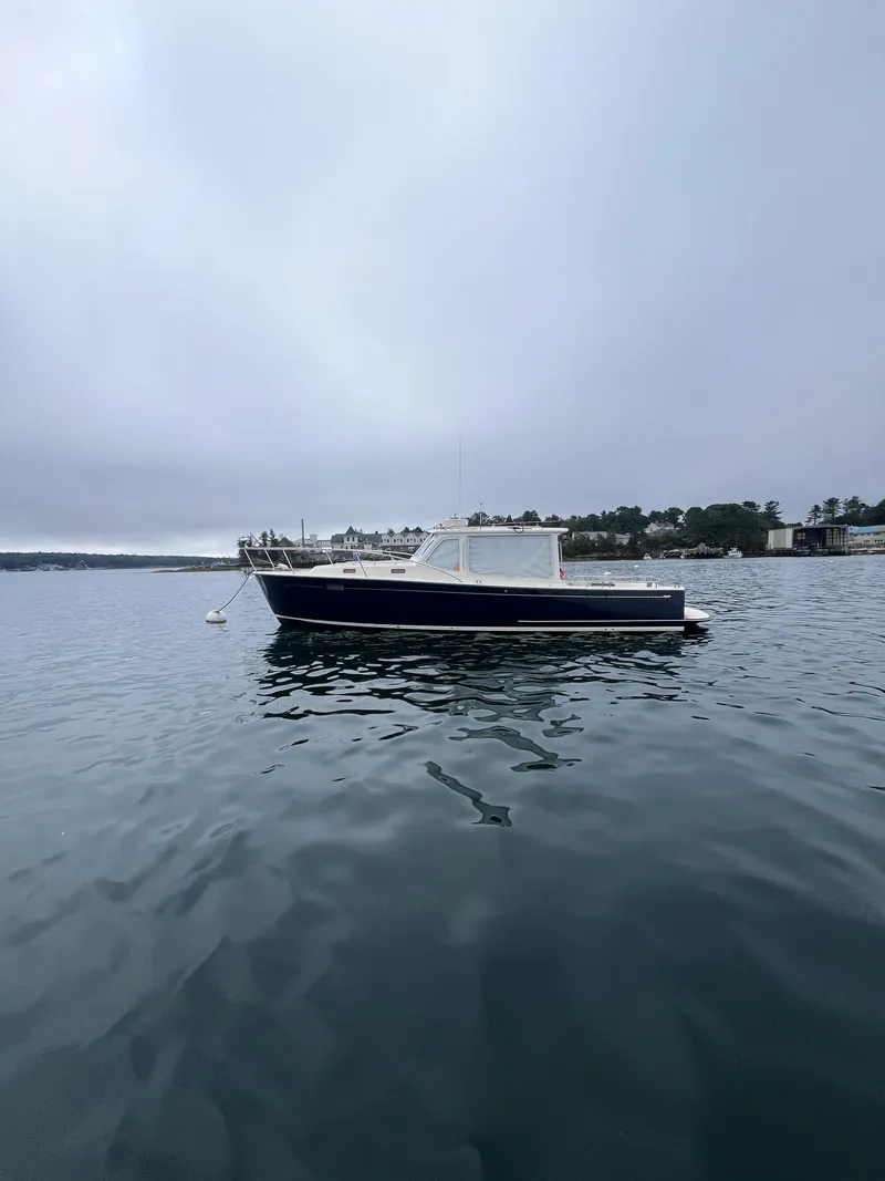 Slide: The Image of 2014 MJM 36z Downeast boat on calm water, overcast sky. - 25