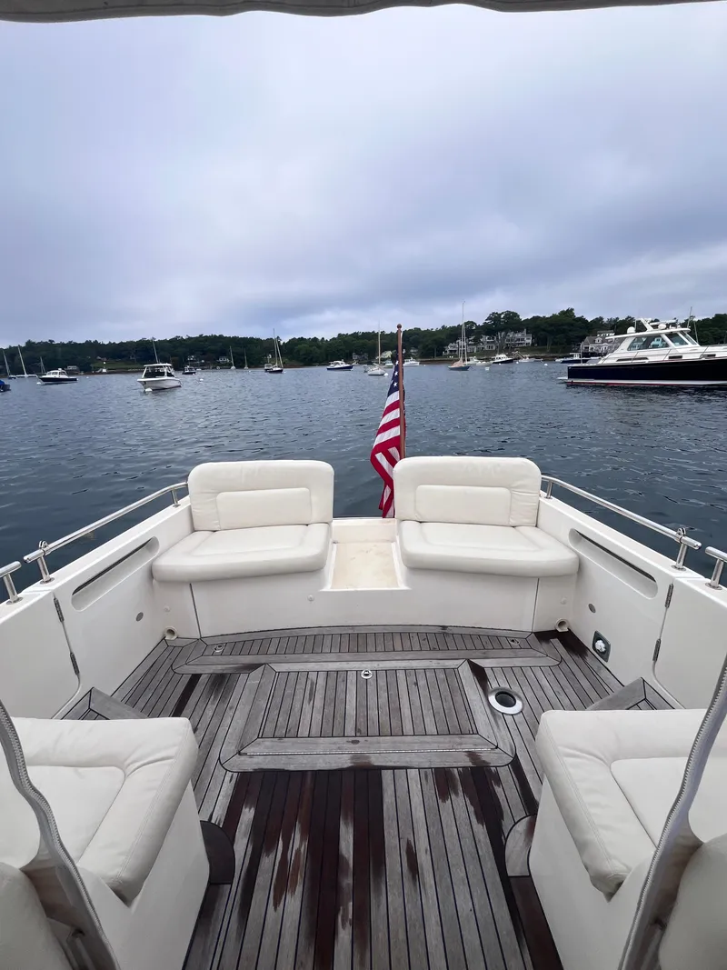 Slide: The Image of 2014 MJM 36z Downeast yacht with spacious deck and seating, overlooking a serene harbor. - 26
