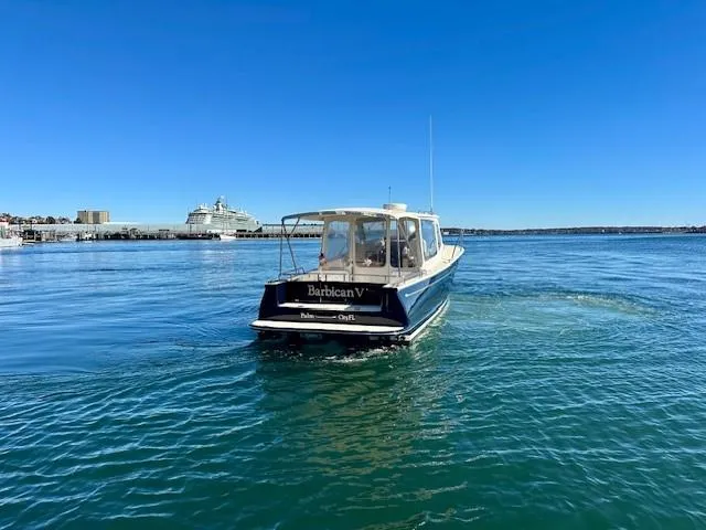 Slide: The Image of 2014 MJM 36z Downeast boat cruising on clear blue water. - 4