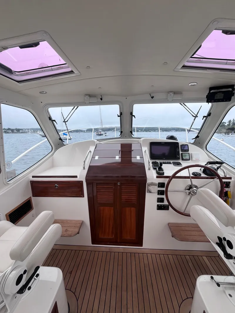 Slide: The Image of Interior of 2014 MJM 36z Downeast boat with steering wheel and navigation equipment. - 40