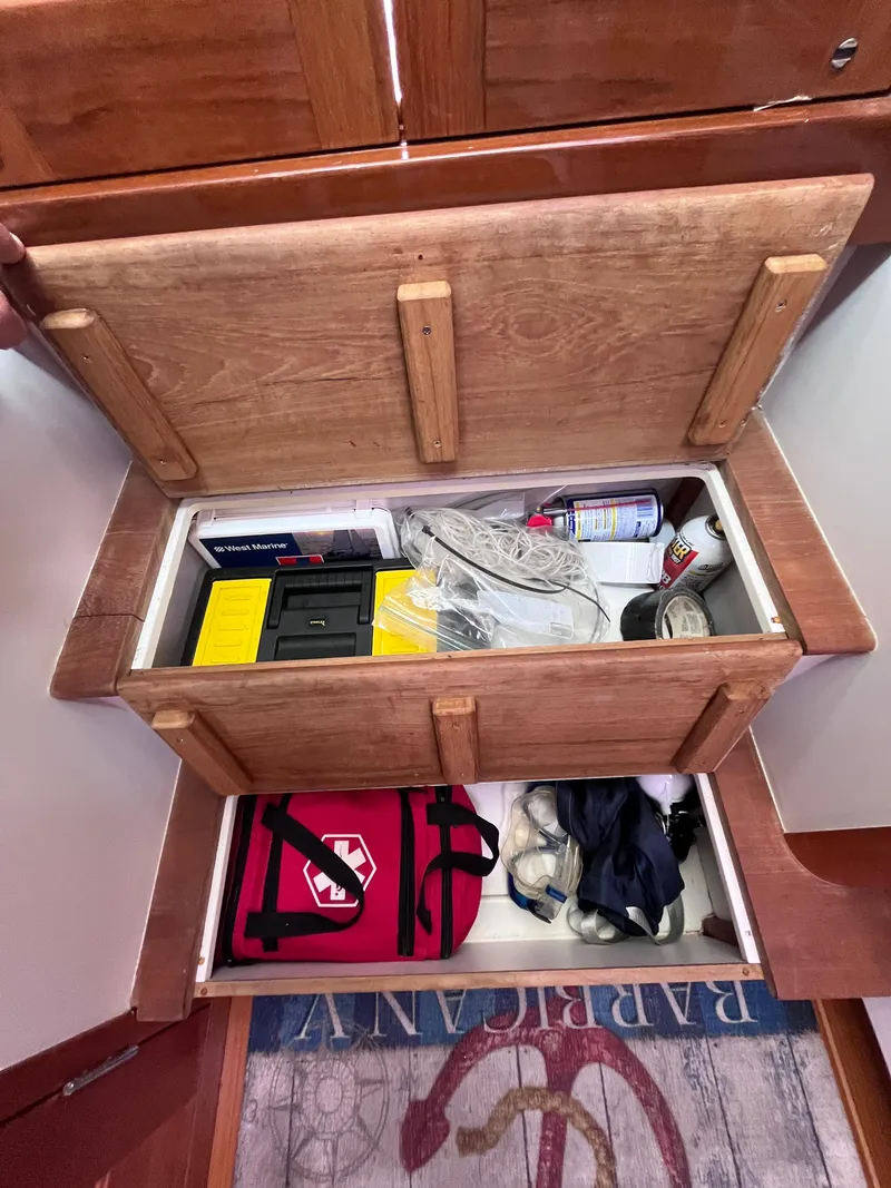 Slide: The Image of Open storage compartment in 2014 MJM 36z Downeast boat with various items. - 44