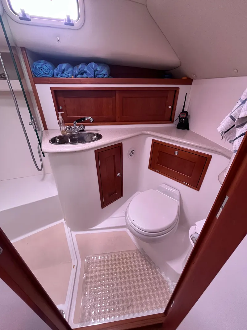 Slide: The Image of 2014 MJM 36z Downeast yacht bathroom with sink, toilet, and storage cabinets. - 47