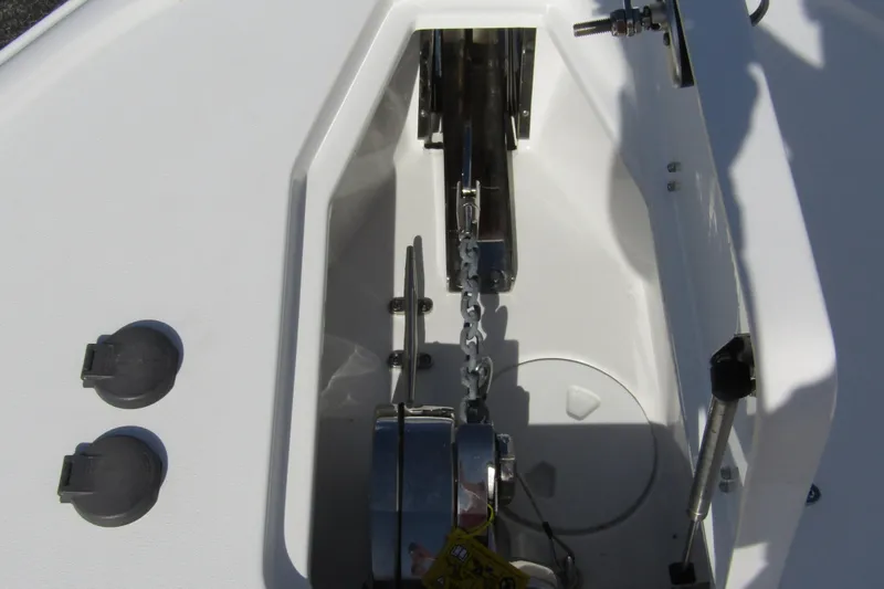 Slide: The Image of Anchor compartment of 2025 Sea Hunt Ultra 275 SE boat, featuring chain and winch system. - 10