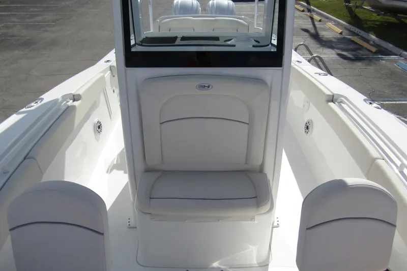 Slide: The Image of 2025 Sea Hunt Ultra 275 SE boat interior with white seating and sleek design. - 17