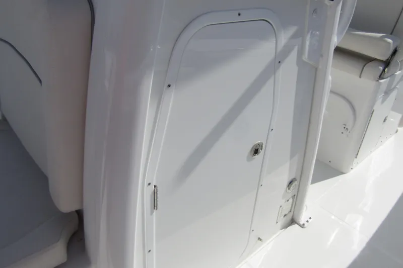 Slide: The Image of 2025 Sea Hunt Ultra 275 SE boat interior, featuring sleek white cabin door. - 18