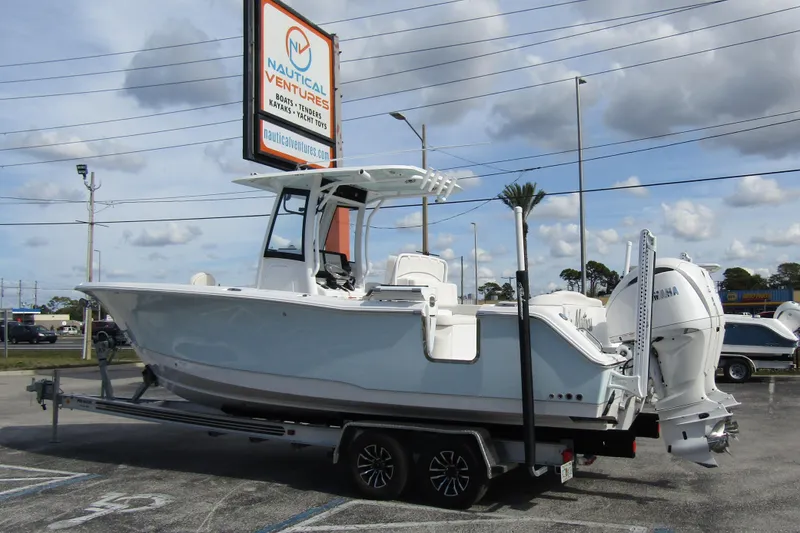 Slide: The Image of 2025 Sea Hunt Ultra 275 SE boat on trailer at Nautical Ventures dealership. - 2