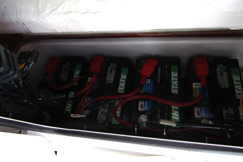 Slide: The Image of Battery compartment of 2025 Sea Hunt Ultra 275 SE with multiple Interstate batteries. - 22
