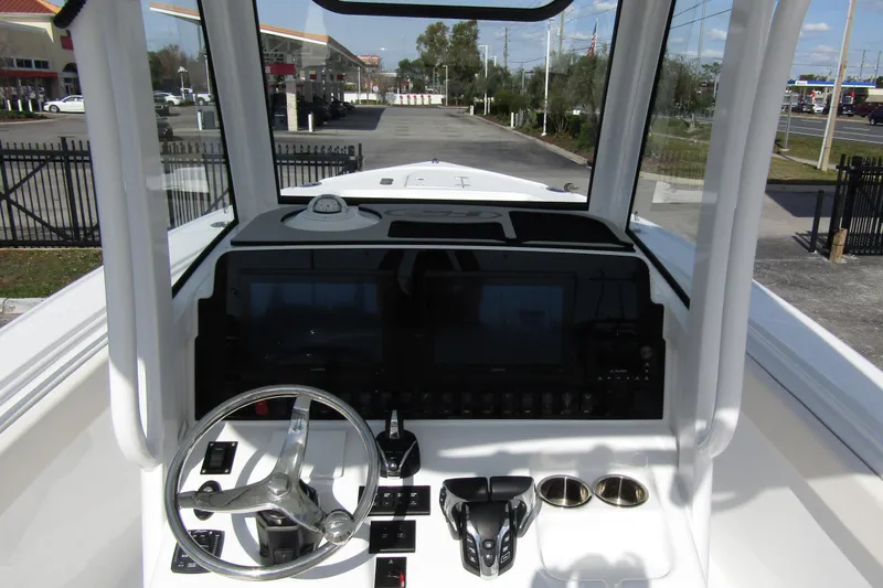 Slide: The Image of 2025 Sea Hunt Ultra 275 SE boat dashboard with steering wheel and controls. - 24