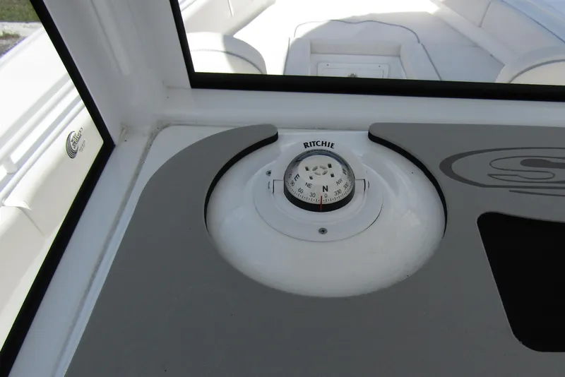Slide: The Image of Compass on 2025 Sea Hunt Ultra 275 SE boat dashboard. - 25