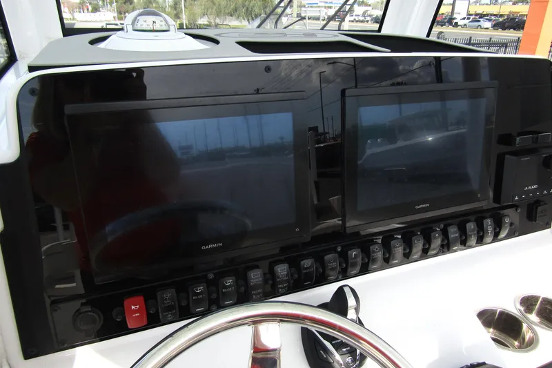Slide: The Image of 2025 Sea Hunt Ultra 275 SE dashboard with dual Garmin displays and control switches. - 26