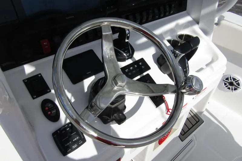Slide: The Image of Steering console of 2025 Sea Hunt Ultra 275 SE boat with modern controls. - 28