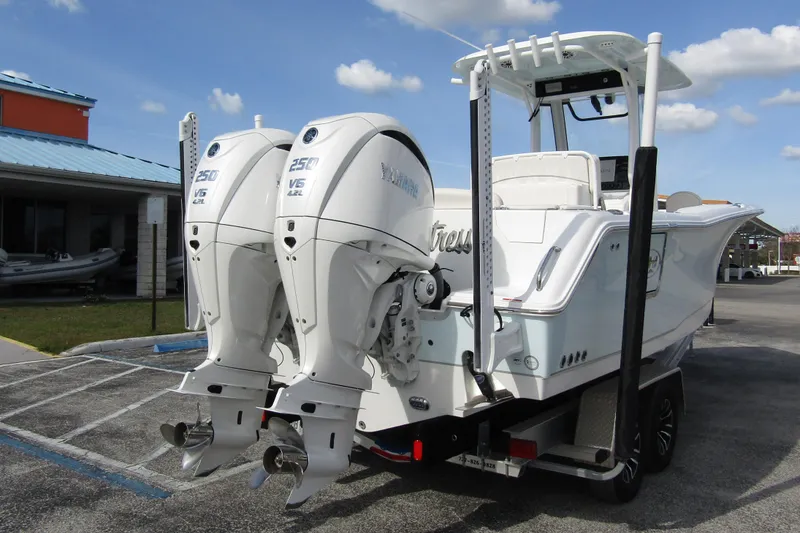Slide: The Image of 2025 Sea Hunt Ultra 275 SE boat with dual Yamaha 250 V6 engines on a trailer. - 3