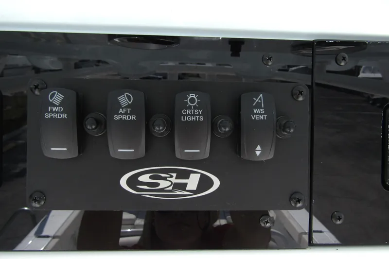 Slide: The Image of Control panel of 2025 Sea Hunt Ultra 275 SE boat with labeled switches. - 32