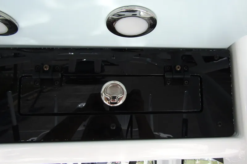 Slide: The Image of 2025 Sea Hunt Ultra 275 SE boat compartment with chrome handle and LED lights. - 33