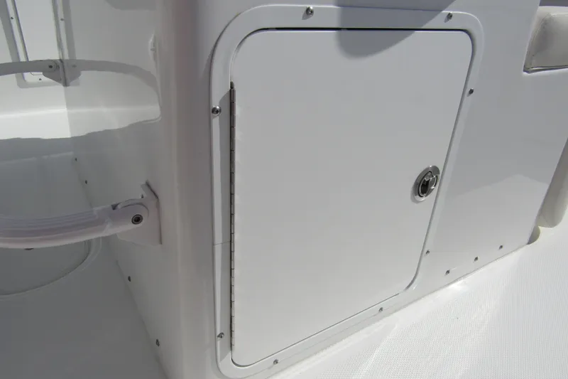 Slide: The Image of 2025 Sea Hunt Ultra 275 SE boat storage compartment with secure latch. - 34