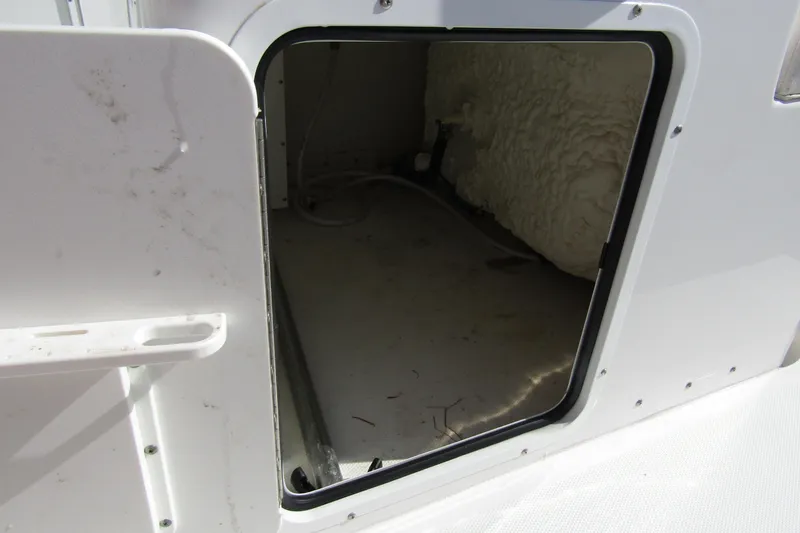 Slide: The Image of Open storage compartment on 2025 Sea Hunt Ultra 275 SE boat. - 35