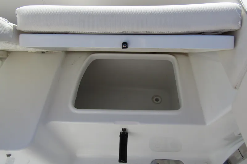 Slide: The Image of Storage compartment on 2025 Sea Hunt Ultra 275 SE boat with cushioned seat. - 39