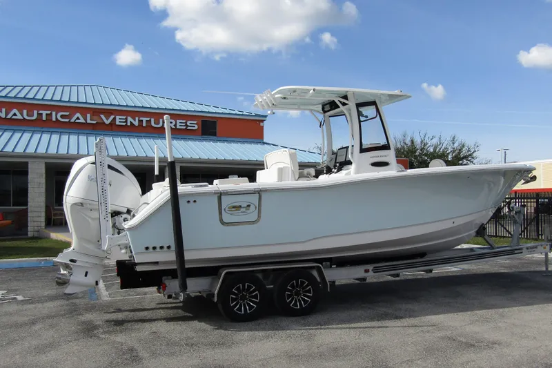 Slide: The Image of 2025 Sea Hunt Ultra 275 SE boat on trailer at Nautical Ventures dealership. - 4