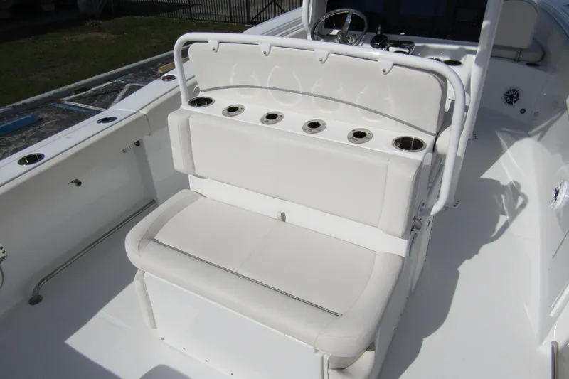 Slide: The Image of 2025 Sea Hunt Ultra 275 SE boat interior with white seating and cup holders. - 43