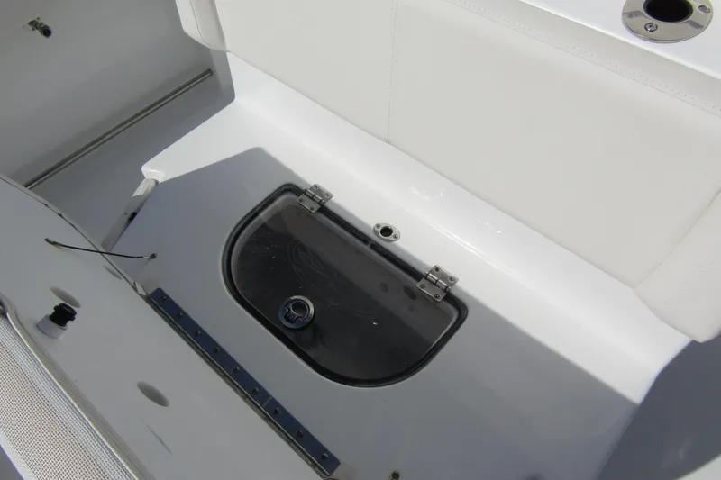 Slide: The Image of 2025 Sea Hunt Ultra 275 SE boat interior with storage compartment and seating. - 45