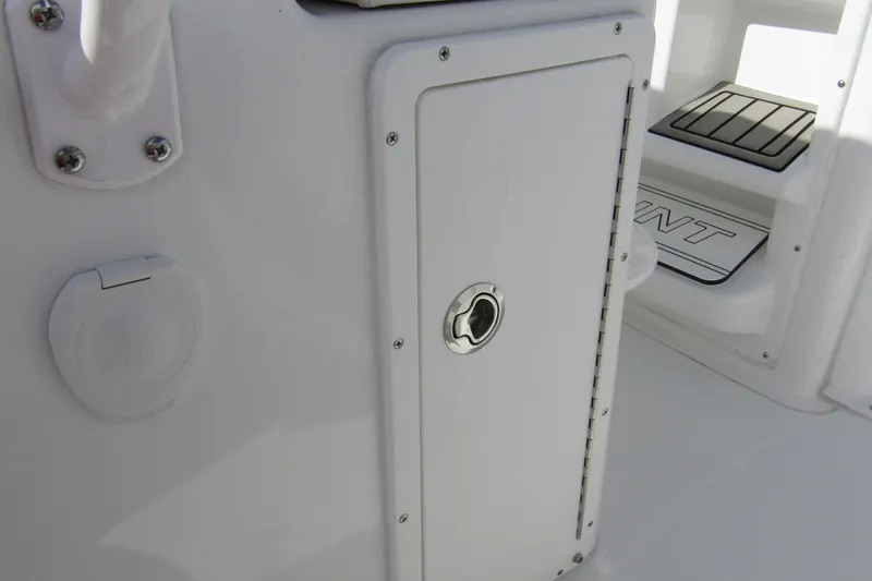 Slide: The Image of 2025 Sea Hunt Ultra 275 SE boat interior, featuring storage compartment and step detail. - 46