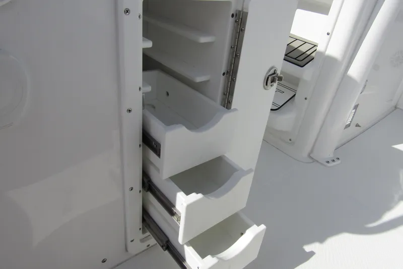 Slide: The Image of Open storage drawers on a 2025 Sea Hunt Ultra 275 SE boat. - 47