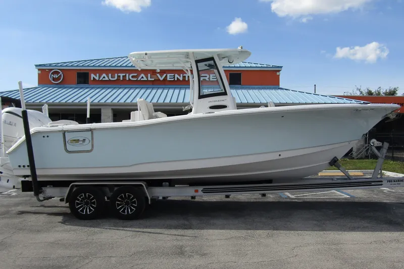 Slide: The Image of 2025 Sea Hunt Ultra 275 SE boat on trailer at Nautical Ventures dealership. - 5