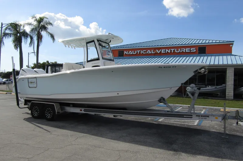 Slide: The Image of 2025 Sea Hunt Ultra 275 SE boat on trailer at Nautical Ventures dealership. - 6