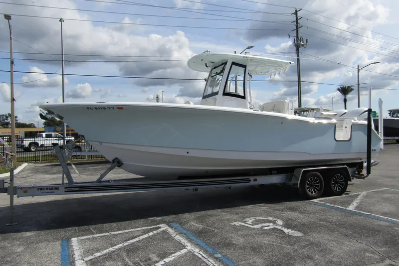 Slide: The Image of 2025 Sea Hunt Ultra 275 SE boat on trailer in parking lot. - 7