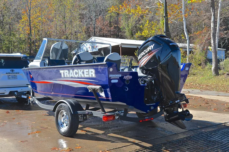 Slide: The Image of 2017 Tracker Pro Guide V-16 WT boat with Mercury engine on trailer, outdoors. - 12