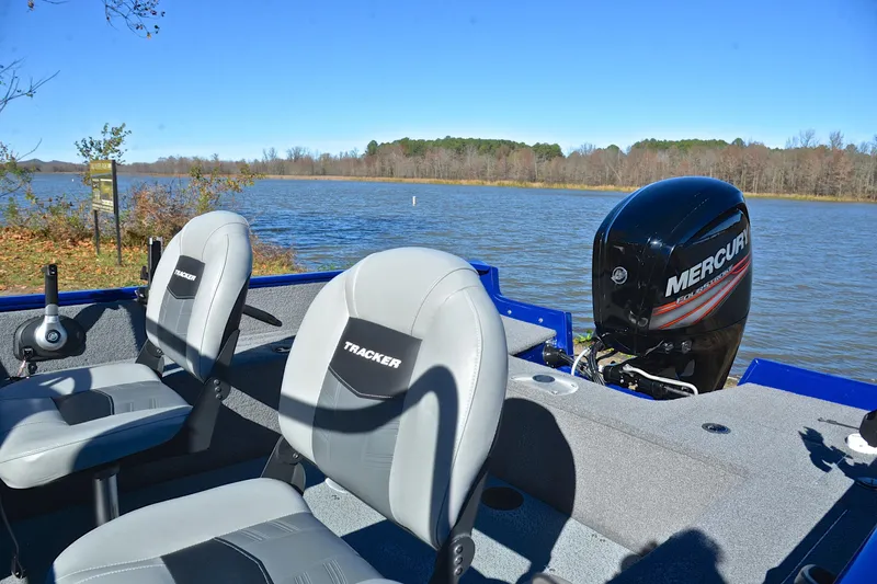 Slide: The Image of 2017 Tracker Pro Guide V-16 WT boat with Mercury engine on a serene lake. - 18