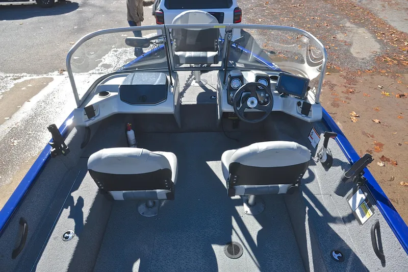 Slide: The Image of 2017 Tracker Pro Guide V-16 WT boat interior with steering console and seating. - 19