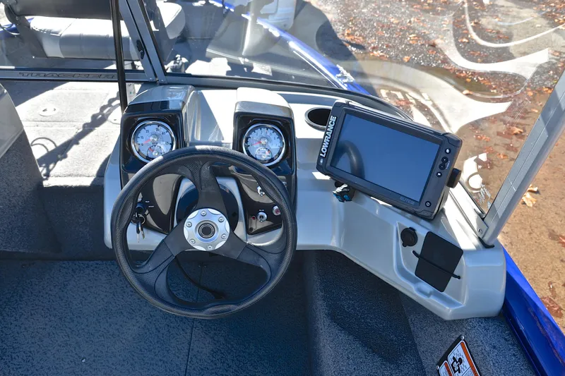 Slide: The Image of 2017 Tracker Pro Guide V-16 WT boat dashboard with steering wheel and navigation system. - 24