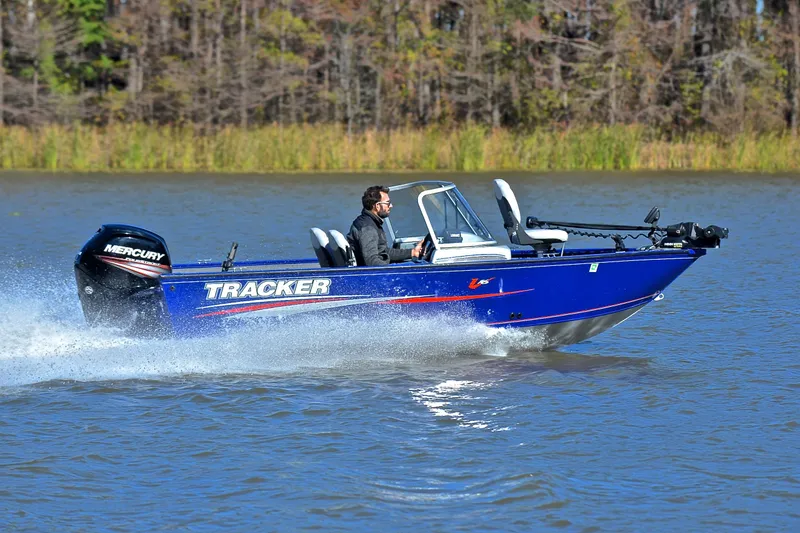 Slide: The Image of 2017 Tracker Pro Guide V-16 WT boat speeding on a lake with a Mercury engine. - 3