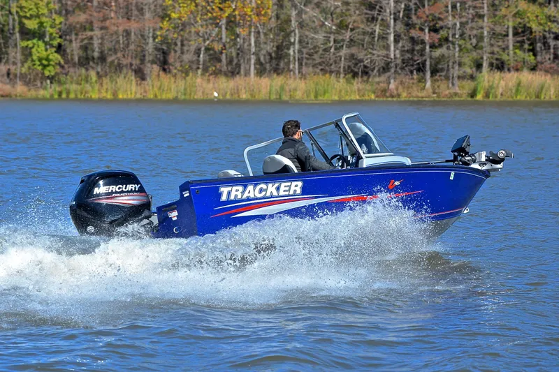 Slide: The Image of 2017 Tracker Pro Guide V-16 WT boat speeding on a lake with Mercury engine. - 5