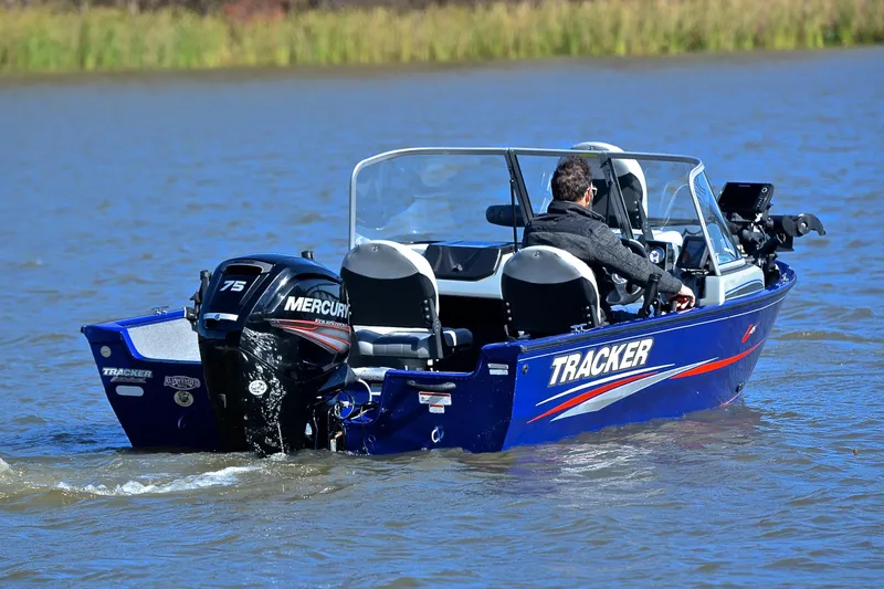 Slide: The Image of 2017 Tracker Pro Guide V-16 WT boat on water with Mercury engine. - 8