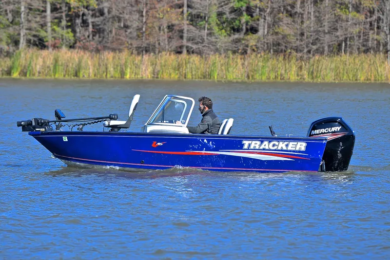 Slide: The Image of 2017 Tracker Pro Guide V-16 WT boat on a lake, featuring Mercury outboard motor. - 9