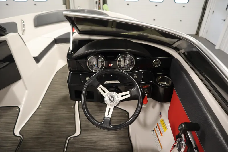 Slide: The Image of 2018 Four Winns H190 boat interior with steering wheel and dashboard controls. - 18
