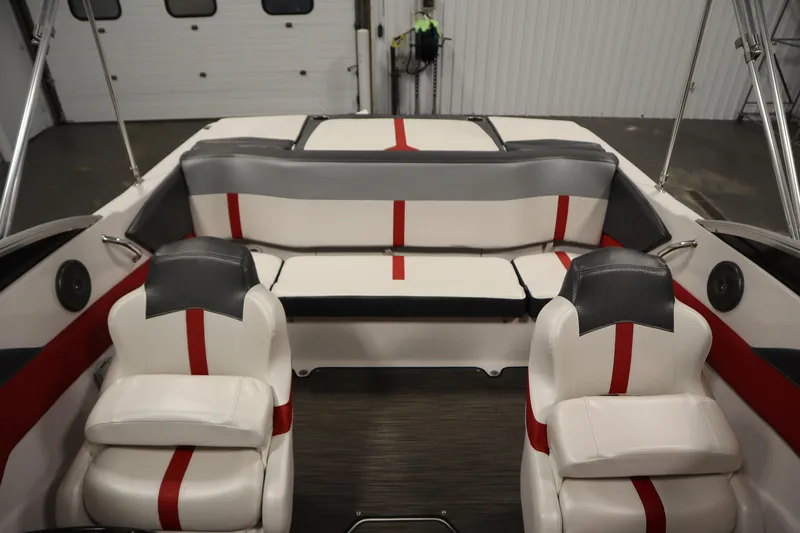 Slide: The Image of 2018 Four Winns H190 boat interior with red and gray seating in a garage setting. - 33