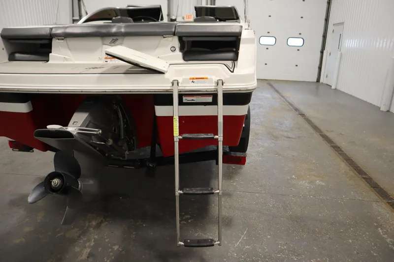 Slide: The Image of 2018 Four Winns H190 boat rear view with ladder and propeller in a garage. - 42