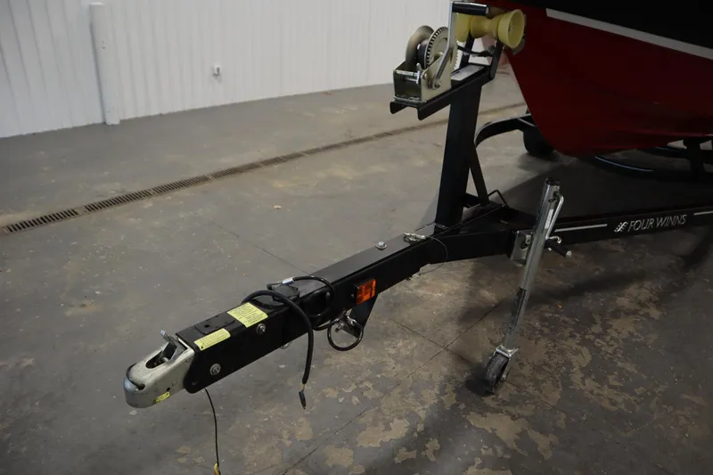 Slide: The Image of Trailer hitch of a 2018 Four Winns H190 boat in a garage setting. - 46