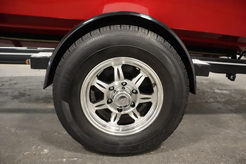 Slide: The Image of Trailer wheel of a 2018 Four Winns H190 boat, featuring a shiny metal rim. - 48