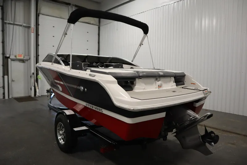 Slide: The Image of 2018 Four Winns H190 boat in a garage, featuring a sleek red and white design. - 7
