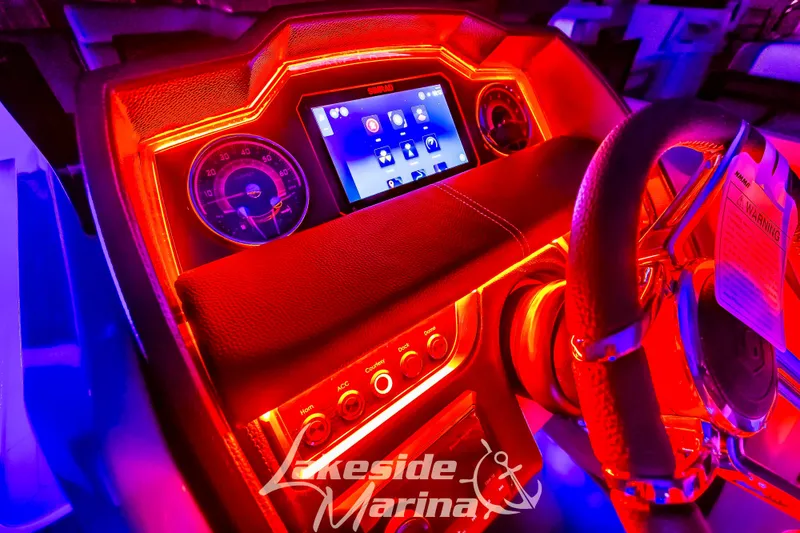 Slide: The Image of Illuminated dashboard of 2025 Godfrey AquaPatio 255 SBC boat with vibrant red lighting. - 11